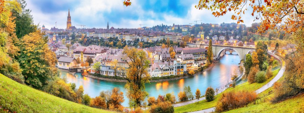 autumn view of Bern city on Aare river during evening with Pont de Nydegg bridge , cathedral of Bern