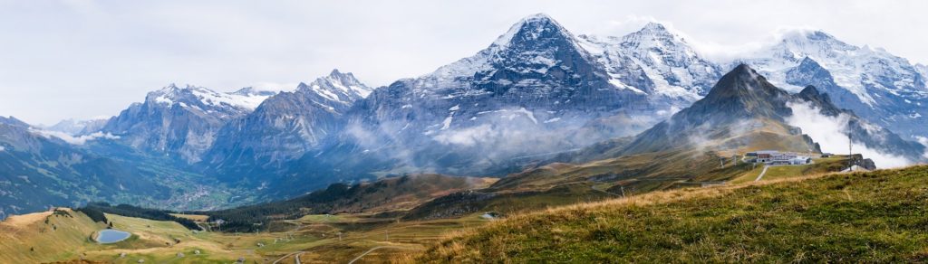 Wide panorama of Grindelwald valley and Swiss Alps. Mountain range from Mannlichen, Switzerland